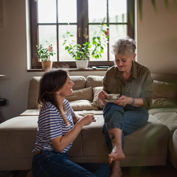 Happy Senior Mother having tea with Adult Daughter
