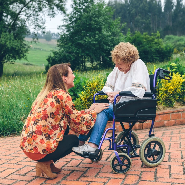 Carer talks to a woman in a wheelchair